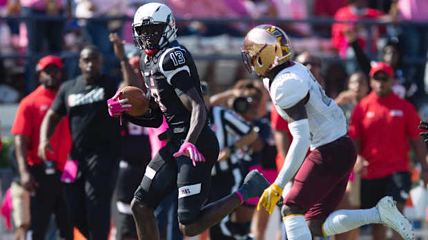 Jackson State's Malachi Wideman runs past a Bethune-Cookman defender during their game at Mississippi Veterans Memorial Stadium in Jackson, Miss.